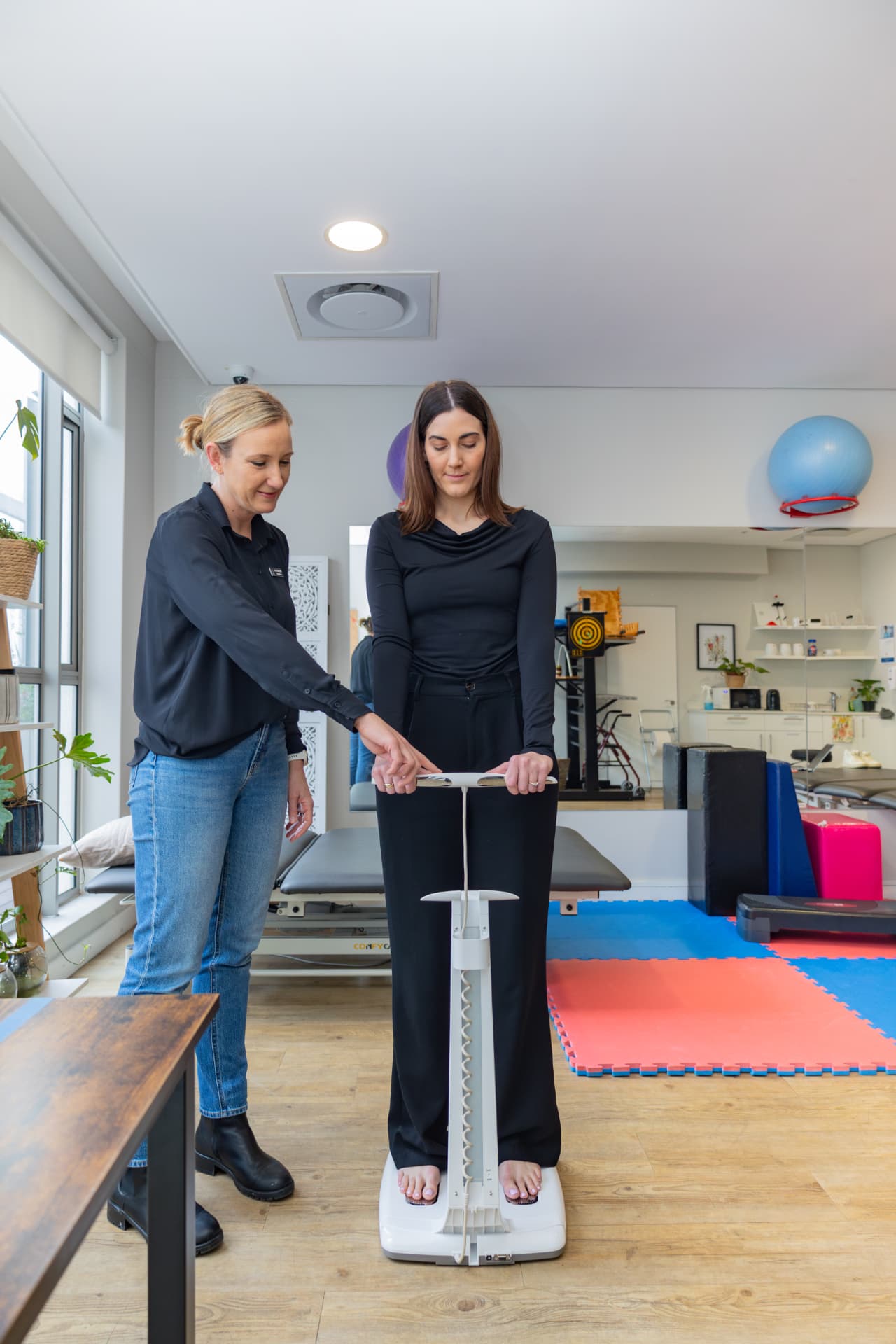 Dietitian guiding a client through a standing InBody body composition scan