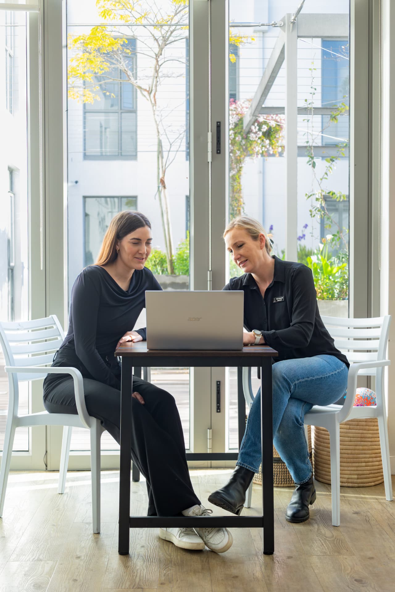 Dietitian and client reviewing a personalised nutrition plan on a laptop